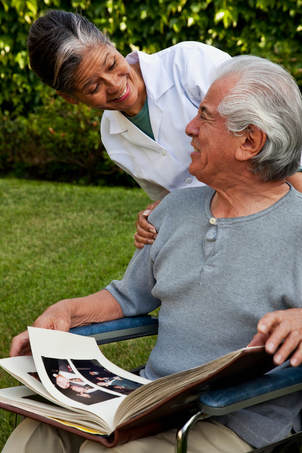 Senior home care aide provides companionship to elderly person.