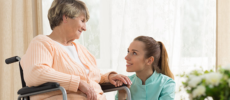 Home care aide offering companionship to elderly woman