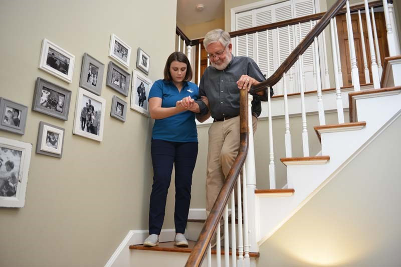 elderly man at home assisted by home health aide
